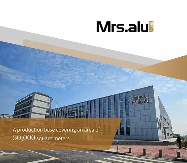 Modern gray glass-and-steel industrial building with ’mrs.alu’ branding on its facade.